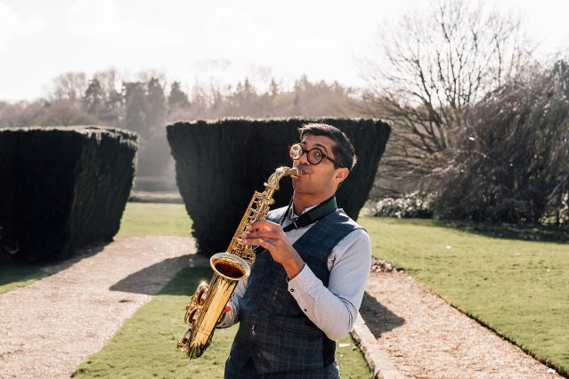 Alex Rimell Sax playing outside at a wedding at St Audries Park. Wedding Heatwave.