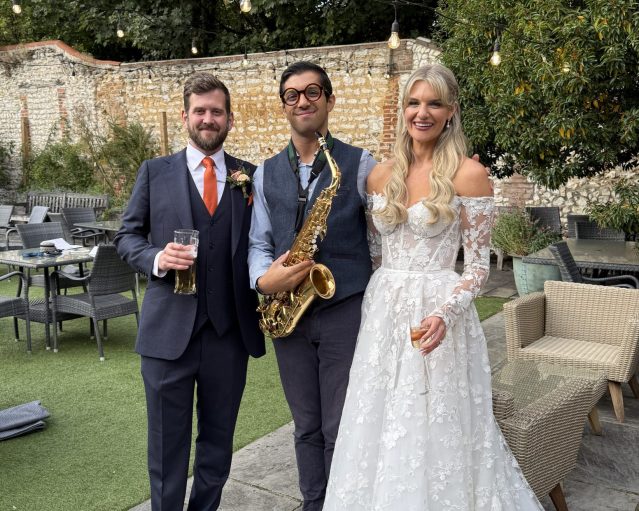 Alex Rimell Sax standing with Bride (Sophie) and Groom (Sam).